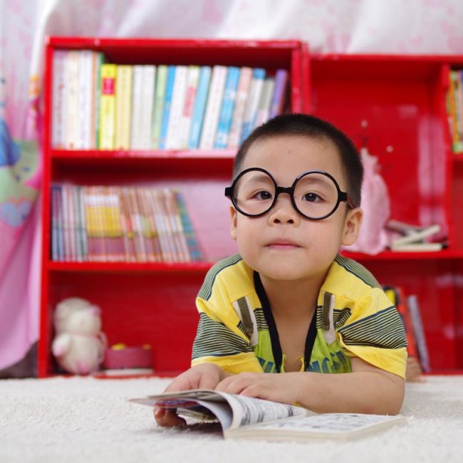 boy reading while wearing pretend Harry Potter glasses